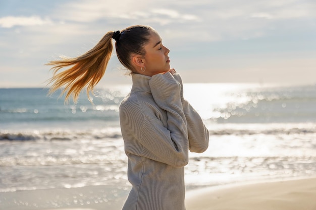 Portrait of a young pretty girl on the background of the sea