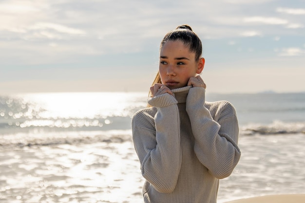 Portrait of a young pretty girl on the background of the sea