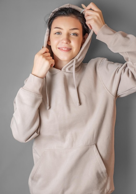 Photo portrait of a young pretty girl in a hoodie