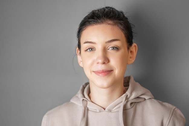 Portrait of a young pretty girl in a hoodie