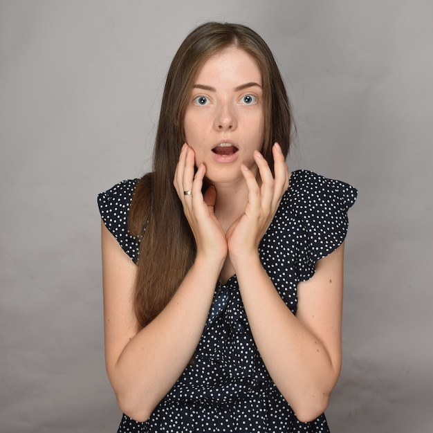 Portrait of a young pretty surprised woman