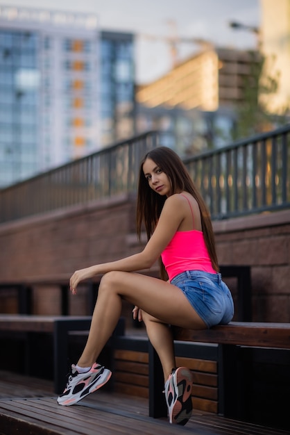 Portrait of a young pretty woman in blue shorts residential complex