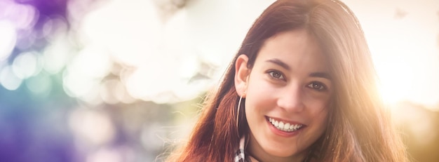 Portrait of young pretty woman on bokeh background and sun lights Teenage girl with natural pure facial skin