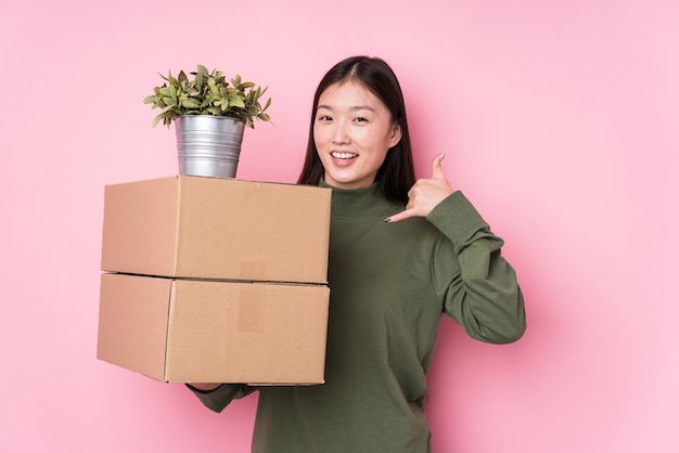 Portrait of a young pretty woman holding boxes