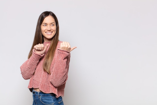 Portrait of a young pretty woman showing something