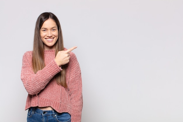 Portrait of a young pretty woman showing something