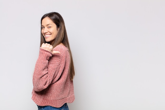 Portrait of a young pretty woman showing something