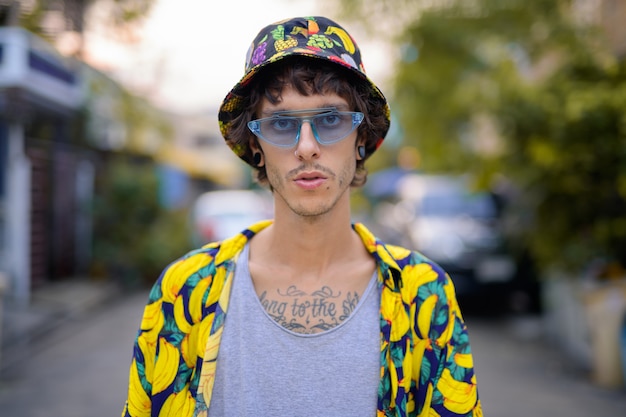 Portrait of young rebellious man in the streets outdoors