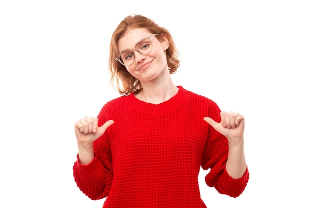 Portrait of young redhead woman smiling looking confident pointing oneself with fingers isolated on white background Chooses herself selfesteem concept