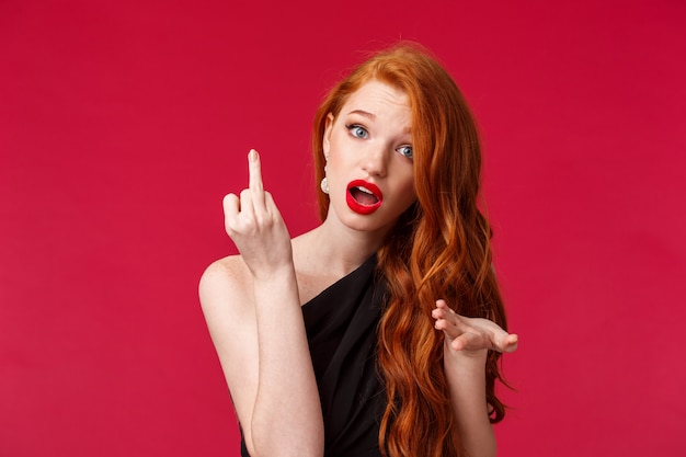 portrait of a young redhead woman with long curly red natural hair