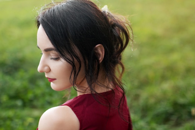 Portrait of young romantic woman in red dress Summertime