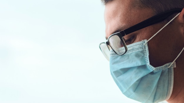 Portrait of young sad and tired doctor isolated on white