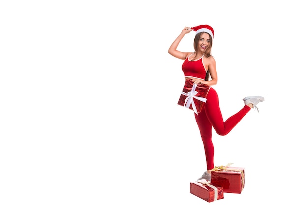 Portrait of young sexy and beautiful woman in sport suit and santa hat white background christmas