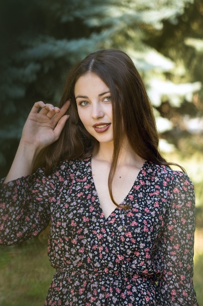 Portrait of a young sexy brunette girl in dress. Vintage photo.