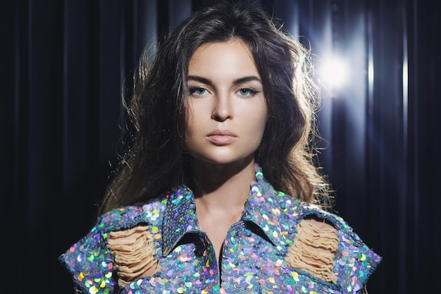 Photo portrait of young sexy woman wearing stylish shimmering jacket covered with a lot of sequins