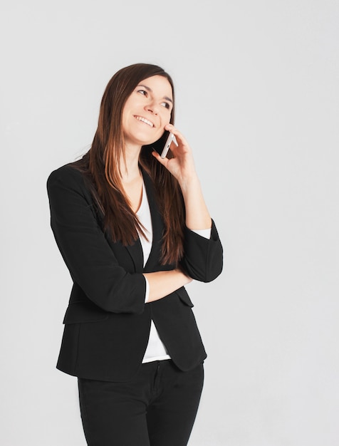 Portrait of young smiling brunette woman lady talking on mobile 