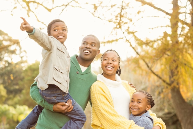 Portrait of a young smiling family pointing something