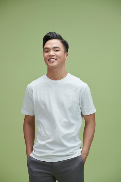 Portrait of young smiling handsome man isolated on gray background