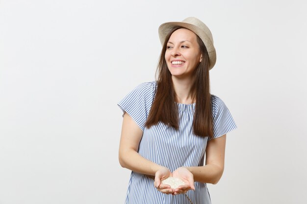 Portrait of young smiling woman hold in hand handful Jasmine Thai Raw rice isolated on white background. Proper nutrition, vegan food vegetarian eating, healthy lifestyle dieting concept. Copy space.