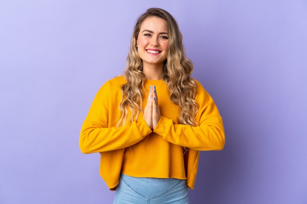 Portrait of a young smiling woman praying