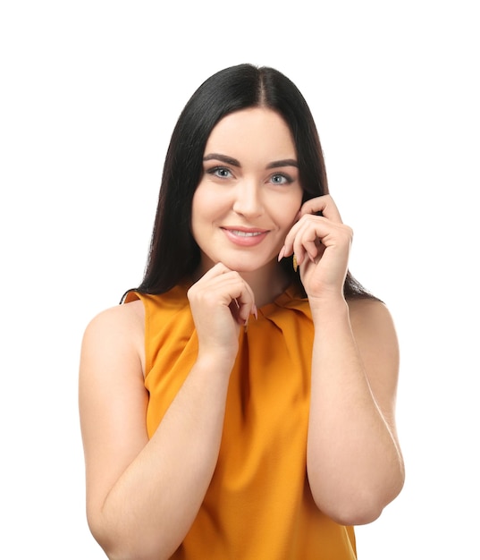 Portrait of young smiling woman on white background