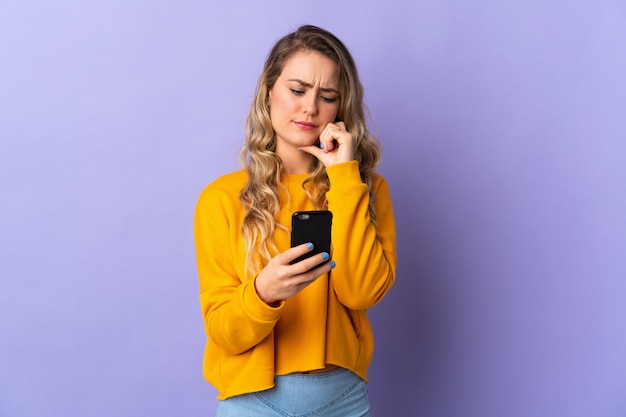 Portrait of a young smiling woman with smartphone