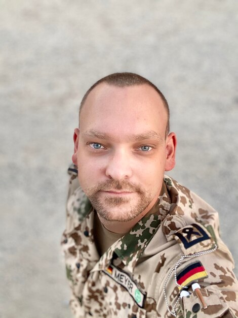 Portrait of young soldier wearing sunglasses