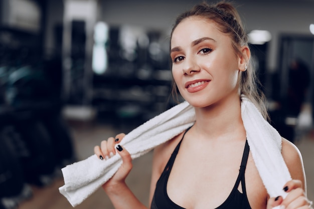 Portrait of a young sporty caucasian woman training in a fitness club close up