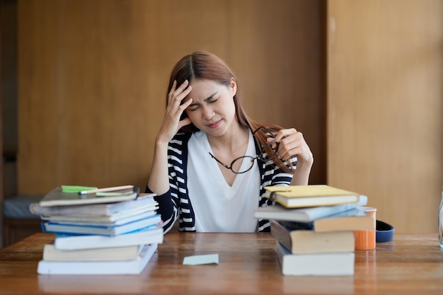 Portrait young stressed displeased worried student woman while reading book for exam