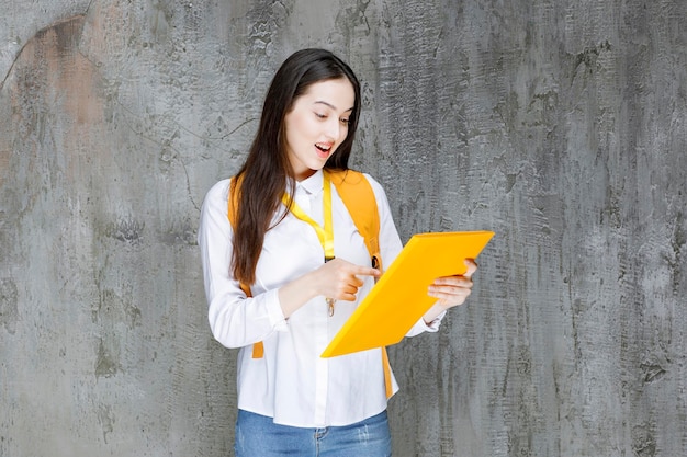 Portrait of young student with notebook standing over stone. High quality photo