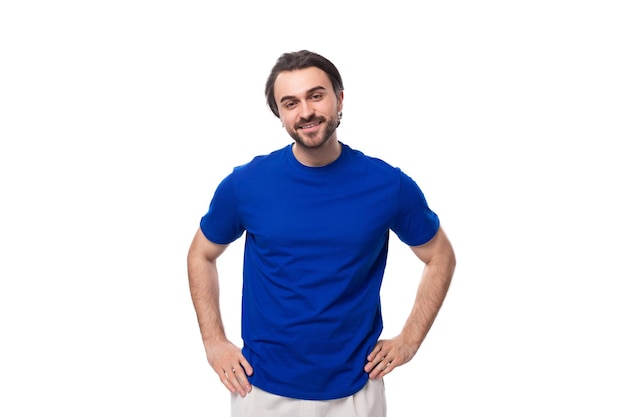 Photo portrait of a young stylish caucasian brunette man with a beard in a blue tshirt