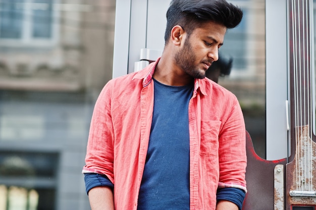 Portrait of young stylish indian man model pose in street.