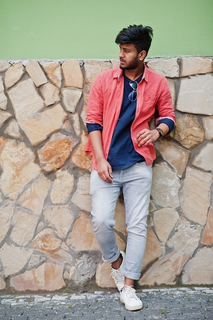 Portrait of young stylish indian man model pose in street.