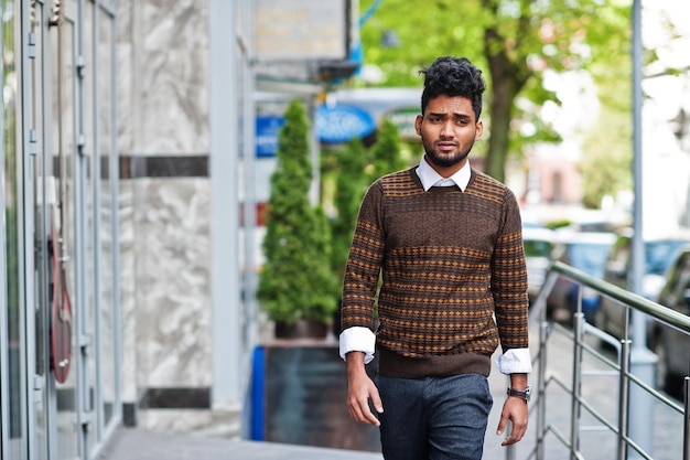 Portrait of young stylish indian man model pose in street