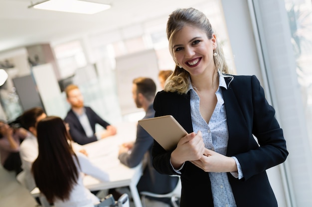 Portrait of young successful architect woman on meeting