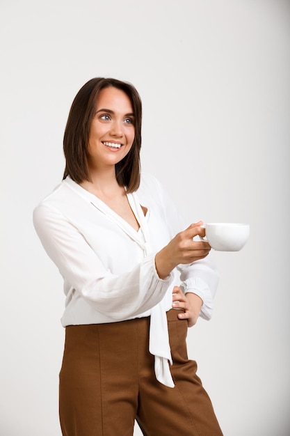 Portrait of young successful business woman over white backgroun