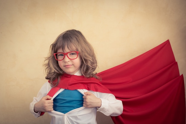 Photo portrait of young superhero kid businessman in office. success, creative and innovation concept