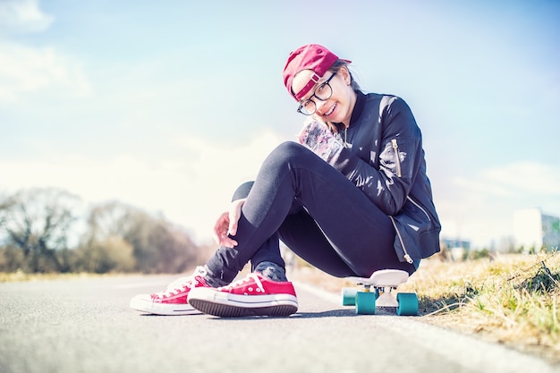 Portrait of young teenage girl on penny board.