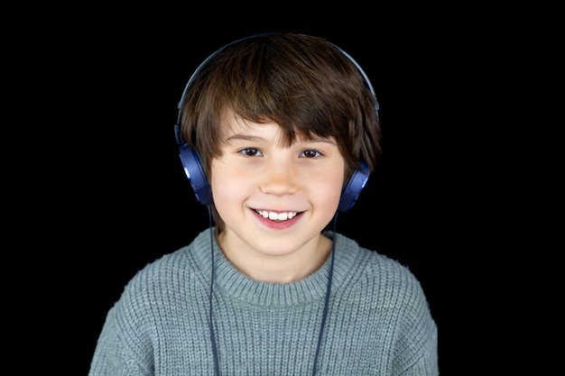 Portrait of a young teenager with headphones on black background Music lover Digital technology concept Generation z