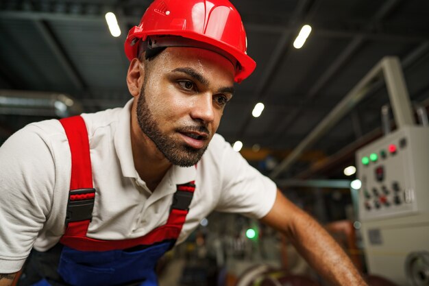 Portrait of young tired african american workman in cable production plant