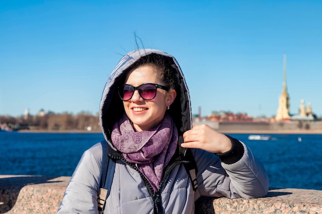 Portrait young tourist woman, walking and enjoys of sights of St. Petersburg. Concept of amazing travel and unforgettable adventures. Copy space