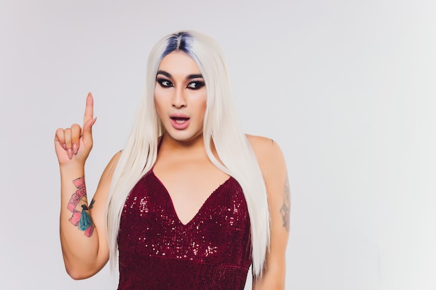 Portrait of young transgender woman on red dress with sequins