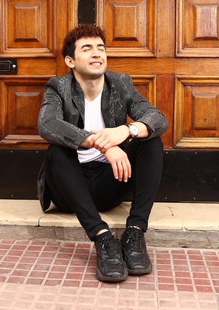 Portrait of young wear a chaquet  happy waiting times at downtown with wood background