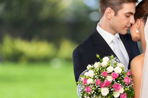 Portrait of young wedding couple embracing