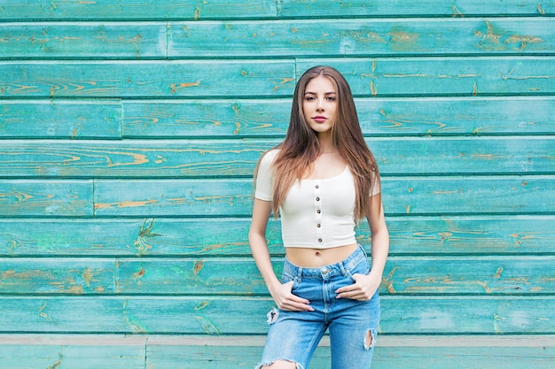 Photo portrait of young woman against blue background with copy space