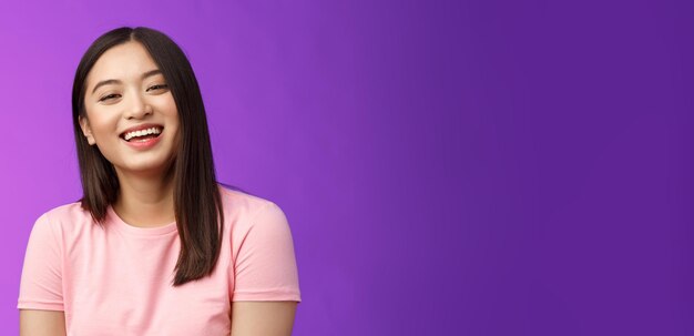 Portrait of young woman against blue background