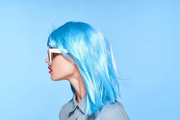 Portrait of young woman against blue background