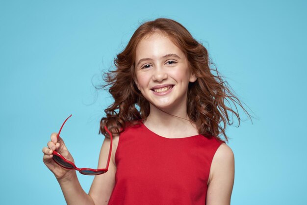 Portrait of young woman against blue background