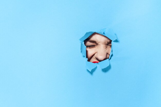 Portrait of a young woman against blue background