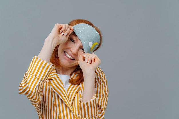 Portrait of young woman against gray background